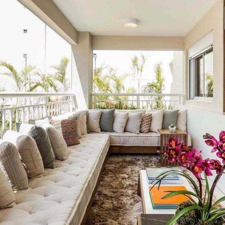 large sofa on the balcony with decorative pillows