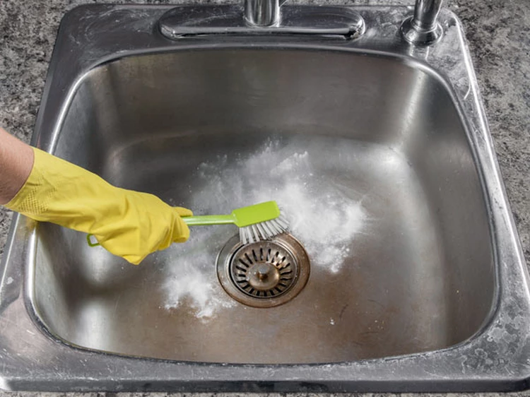 use baking soda and vinegar to clean your stainless steel sink