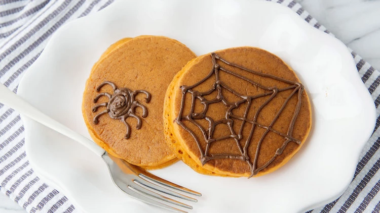Spooky Halloween Pancakes decorated with chocolate