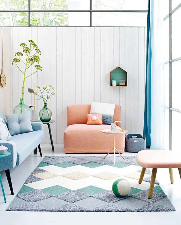 geometric rug and furniture in pastel colors