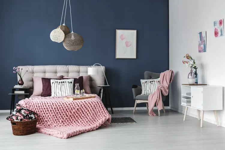 pink throw blanket on bed and armchair