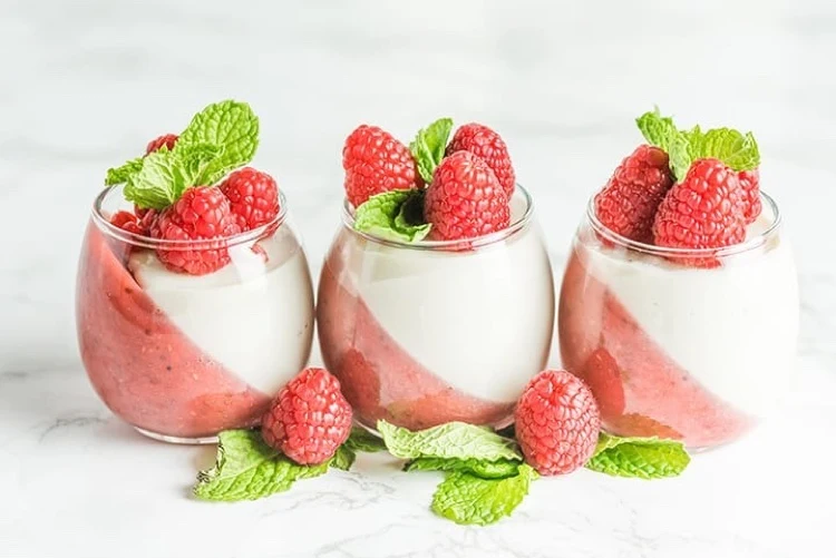 Vegan panna cotta with strawberry and raspberry