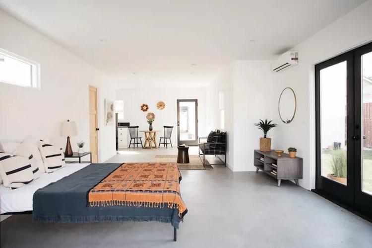 neutral concrete floor and white walls mediterranean style bedroom