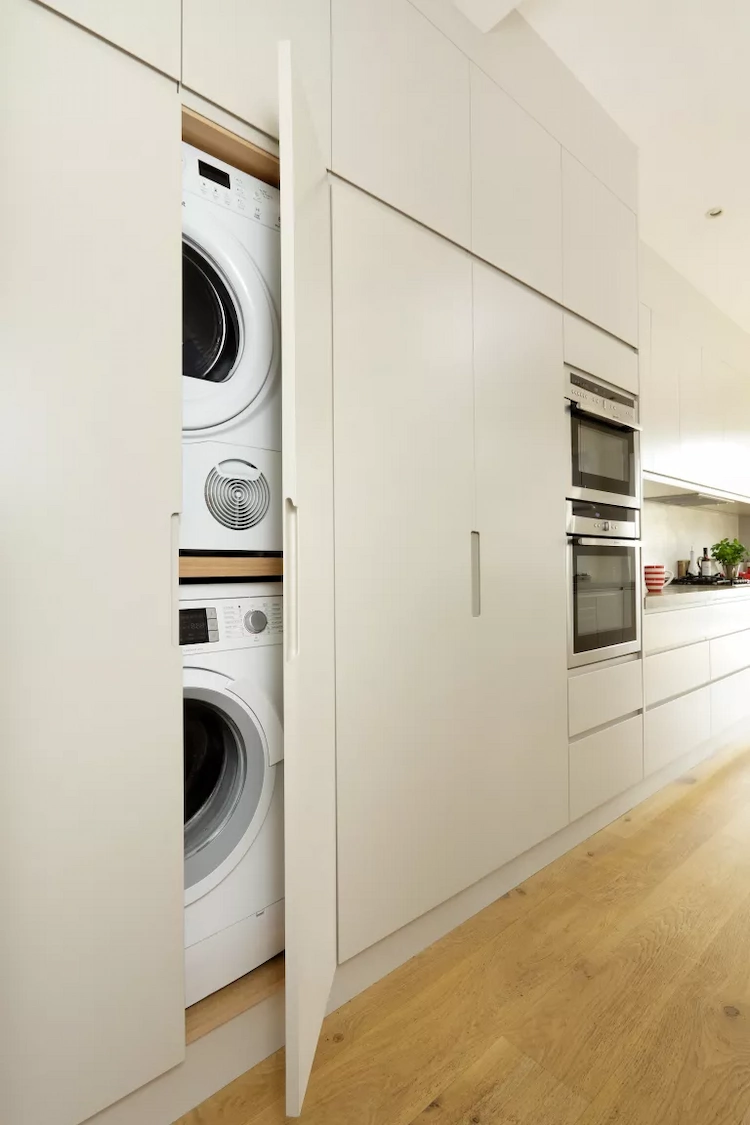 extend the kitchen space and place the washing machine and dryer in built in cabinets