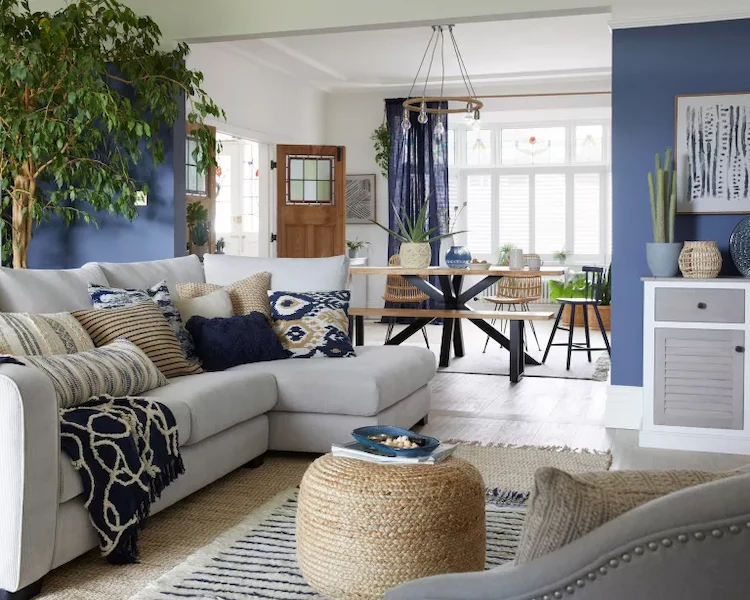 living space in a beach house with sand colored furniture and blue walls