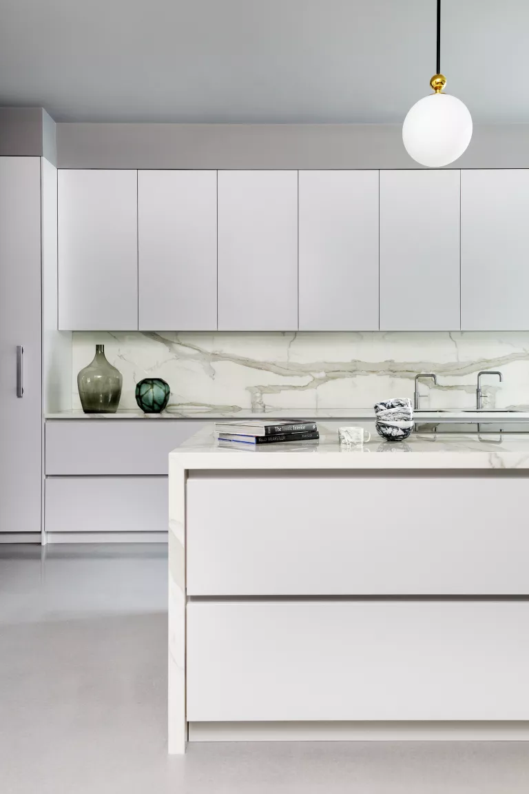 minimalist design with marble accents in a white kitchen