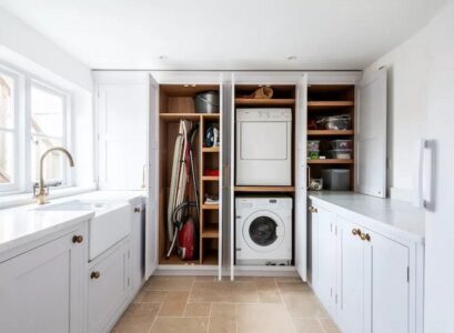 white-laundry-room-with-windows-offers-ample-storage-space