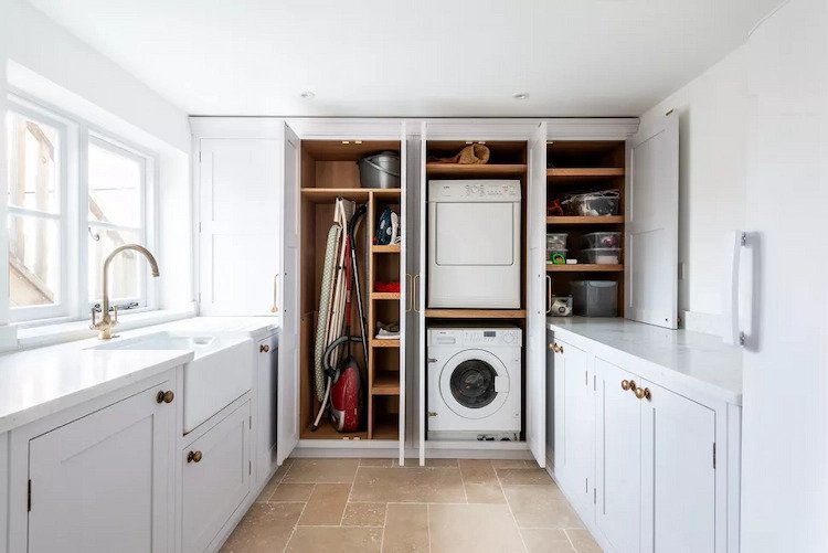 white laundry room with windows offers storage space
