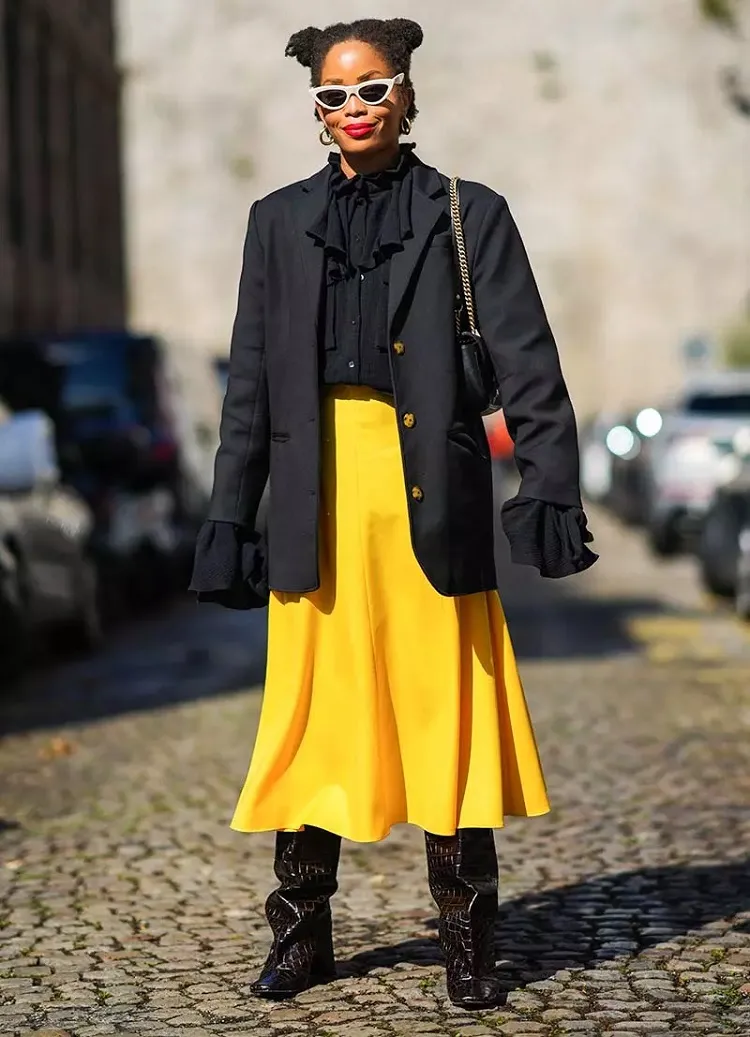 yellow skirt with black blazer and boots