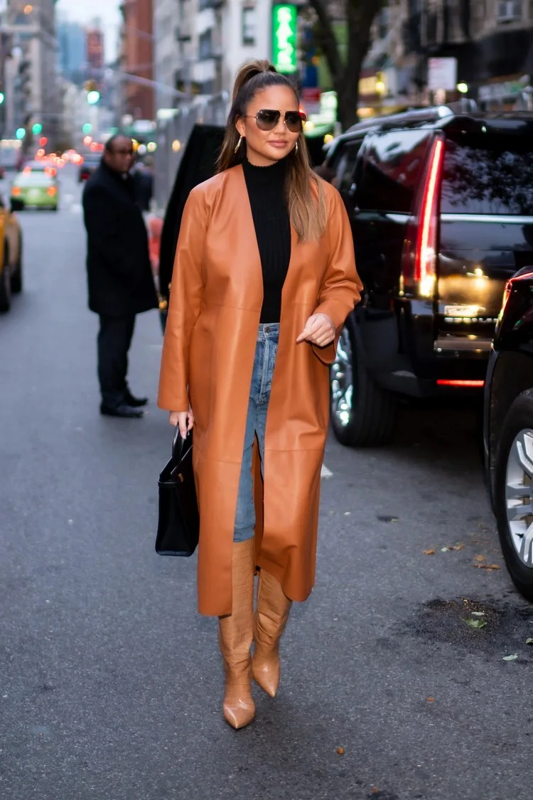 Chrissy Teigen in straight jeans and knee high boots