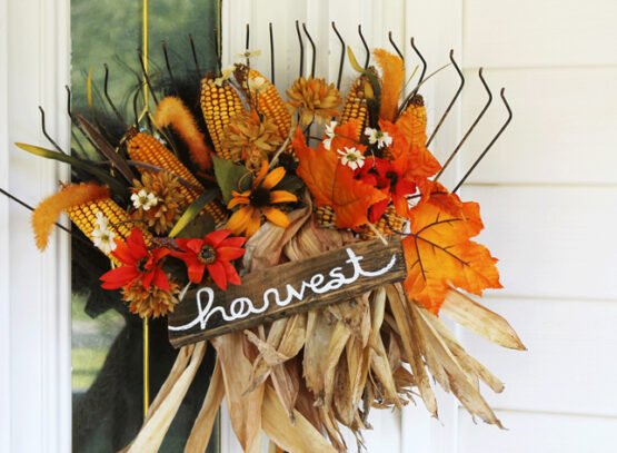 DIY-outdoor-fall-decoration-with-a-rake-and-artificial-flowers