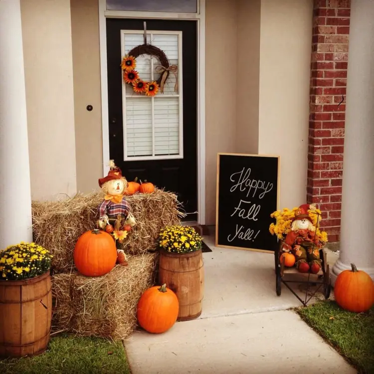 Front door decorate fall with barrels straw bales and pumpkins