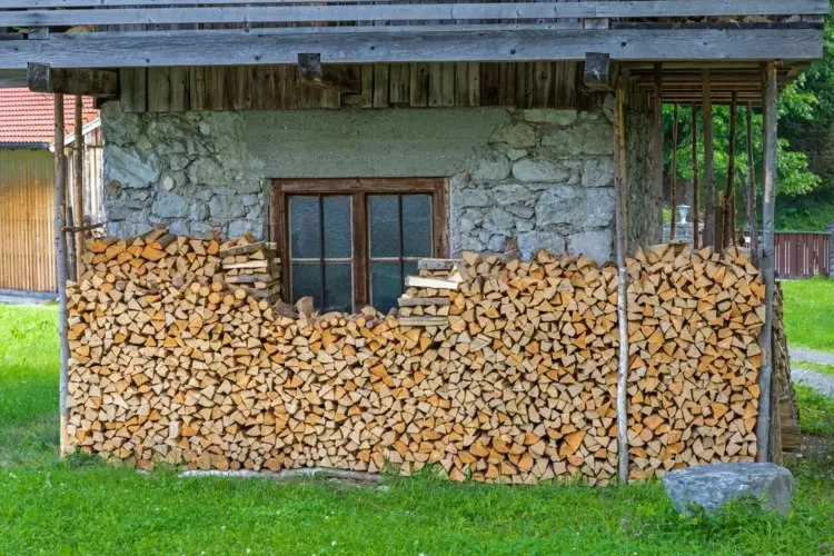 Stack firewood outside leave a distance to the wall for good air circulation
