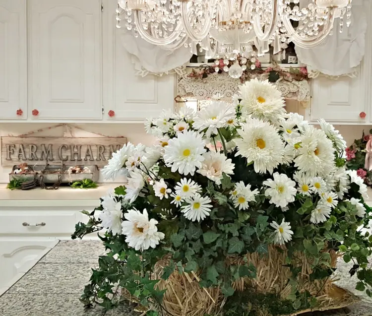 Straw bale decoration with white fall flowers