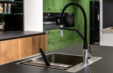 contemporary-kitchen-faucet-in-matt-black-in-combination-with-green-kitchen-cabinets