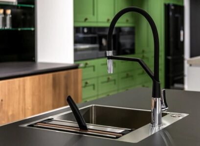 contemporary-kitchen-faucet-in-matt-black-in-combination-with-green-kitchen-cabinets