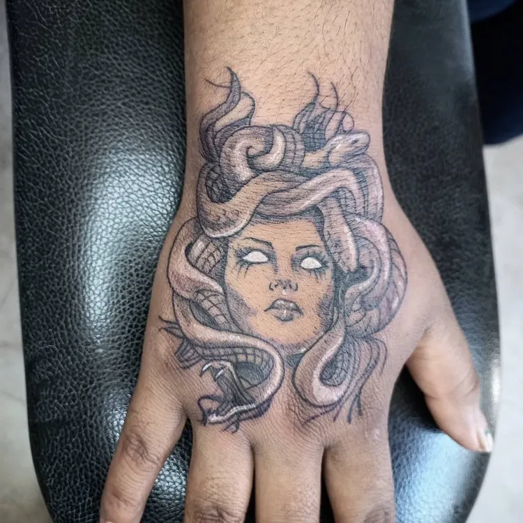 hand tattoo Medusa snake hair