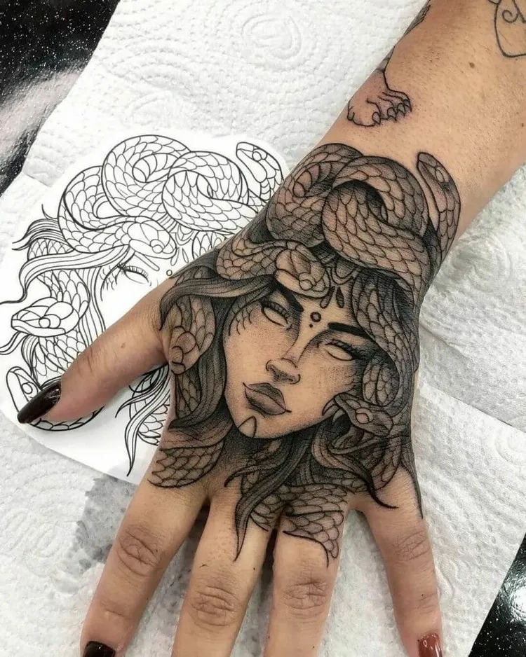 gothic style medusa tattoo on hand woman
