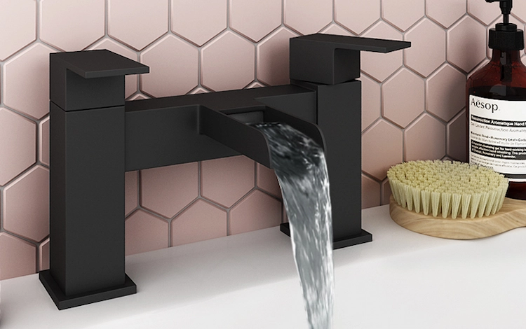 pink tiles with matt black bathroom faucet and white sink in a modern bathroom