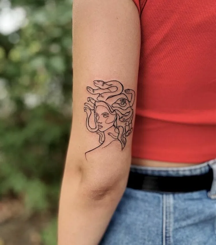 woman discreet tattoo back arm medusa gorgon