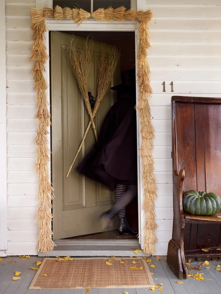 Brooms form a spooky front door Halloween decoration 2022