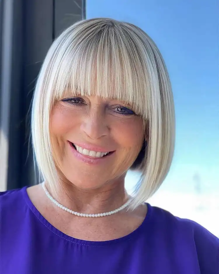 Hairstyles for women over 50 to look younger bob with blunt bangs