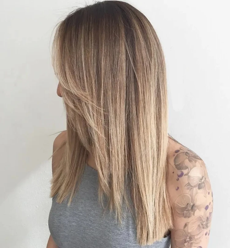Opt for a nicely blended ashy blonde balayage color on warmer blonde hair