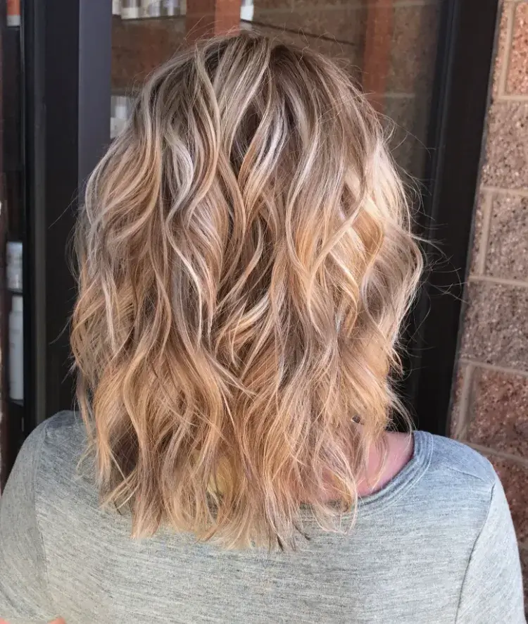 Platinum blonde highlights pink shade wavy bob haircut