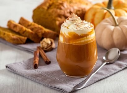 Pumpkin spice latte, hot coffee drink with pumpkins and pumpkin cake bread, healthy autumn dessert food