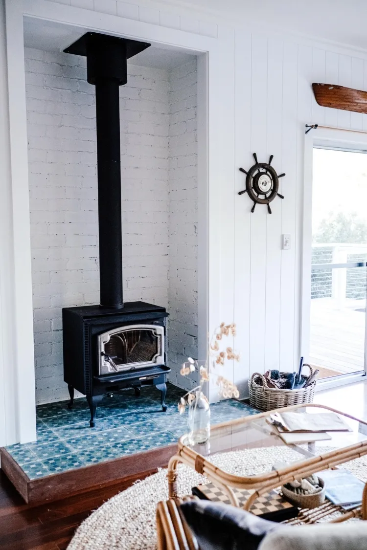 white bricks as heat insulation shield niche with wood stove stylishly adapted to the room