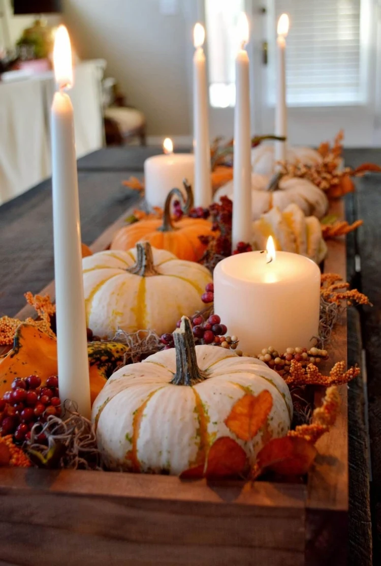 DIY Thanksgiving centerpiece idea candles pumpkins fallen leaves