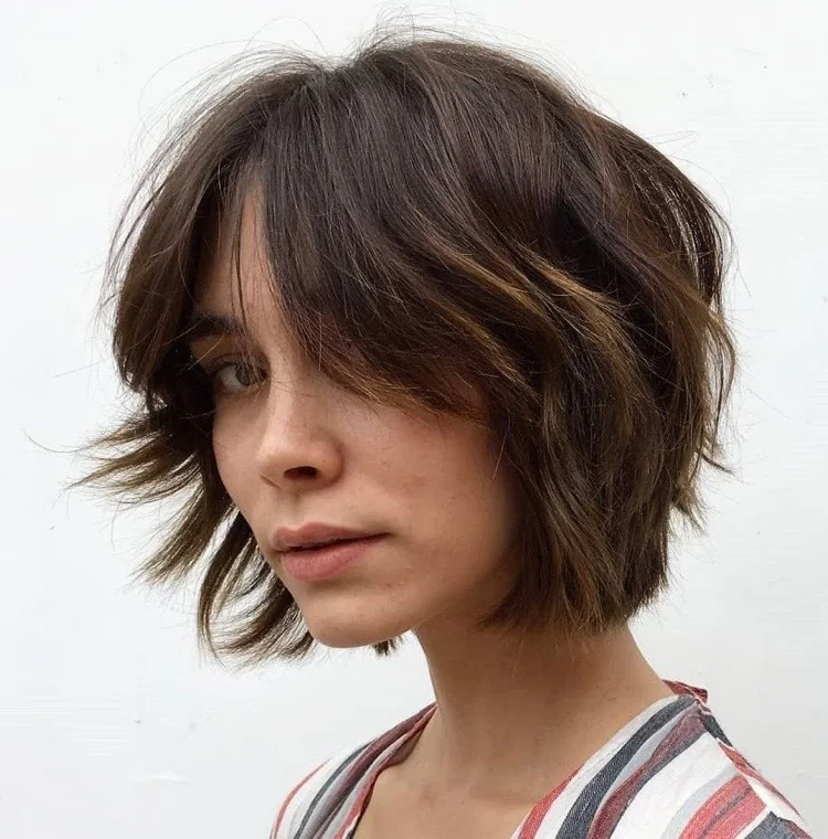 modern hairstyle for women over 40 Layered bob with curtain bangs