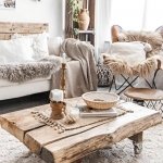 boho chic rustic living room wooden table palette back of a coach rugs cushions blankets