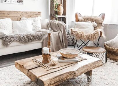 boho chic rustic living room wooden table palette back of a coach rugs cushions blankets