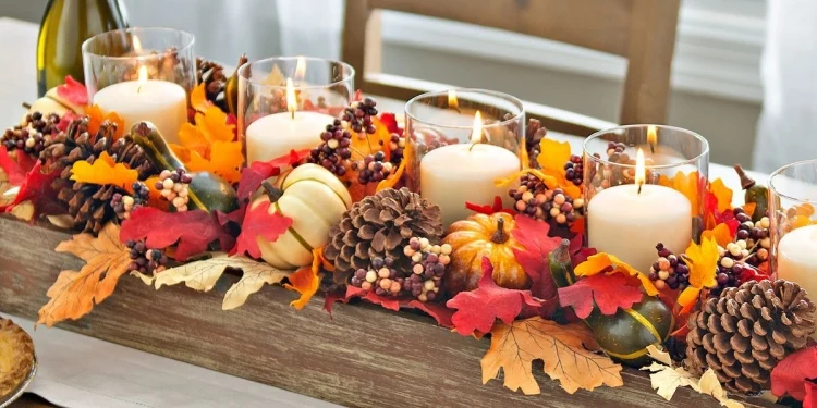 candle centerpiece with cones leaves pumpkins for Thanksgiving dinner