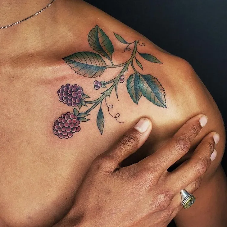 colored tattoo on black skin for women clavicle