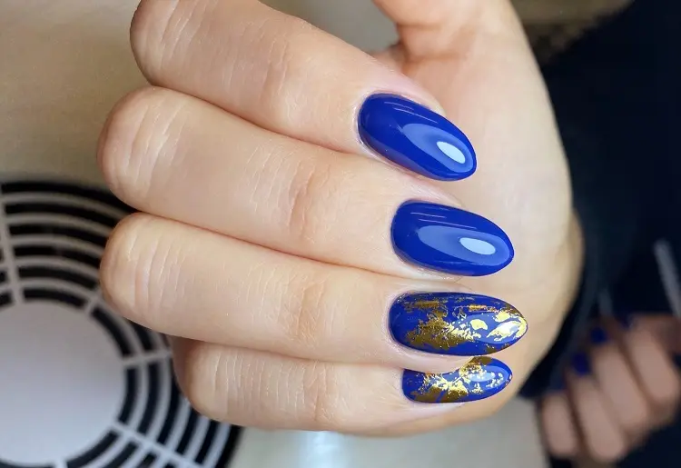 gold foil nail winter trends in 2022 december blue shades nail polish