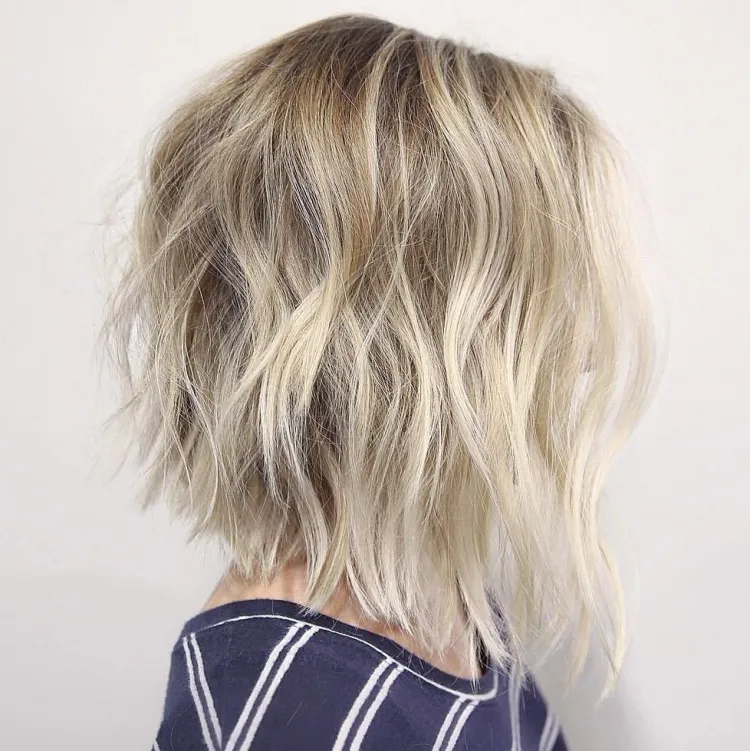 messy a-line bob haircut curled at different directions blond hair trendy haircut