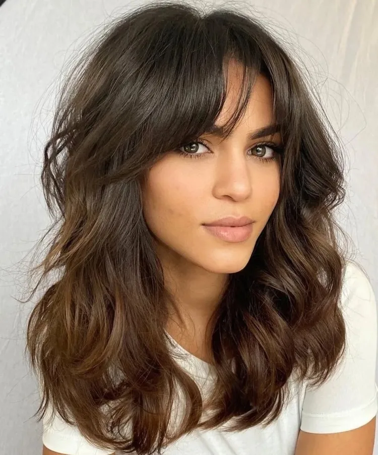 oval face framing layers with bangs brown wavy hair