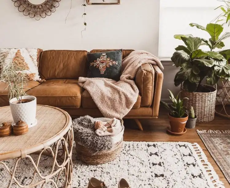 rustic boho chic living room decor idea coffee table natural materials brown leather coach with fluffy cushions