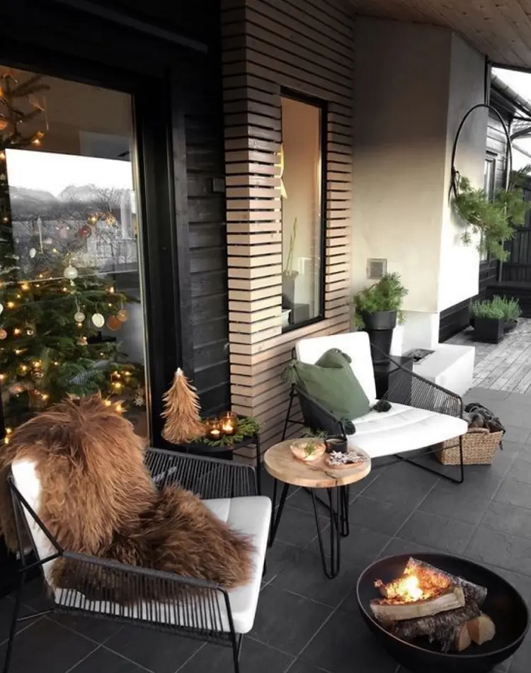 trendy veranda ideas for Christmas front porch cozy blankets chairs fire and wood
