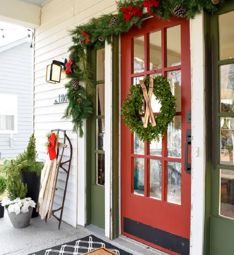 veranda deocration for christmas wreath garland red bows pine cones vintage ski