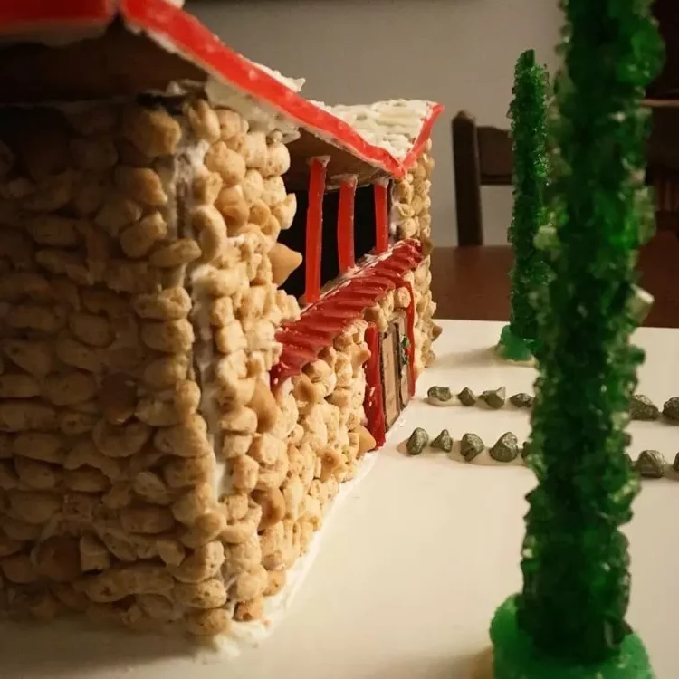 Decorate a gingerbread house facade with cereals to imitate stone