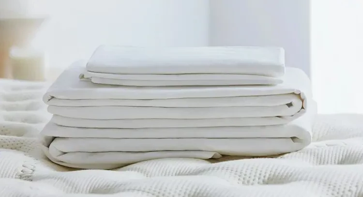 Fold the bed sheets into strips and then fold into a square Marie Kondo method