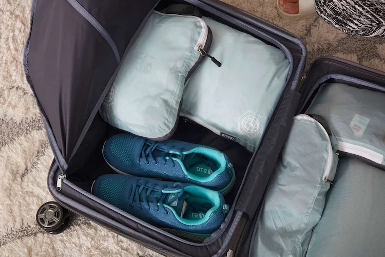 Using packing cubes compresses your clothes into a flexible cube shaped bag