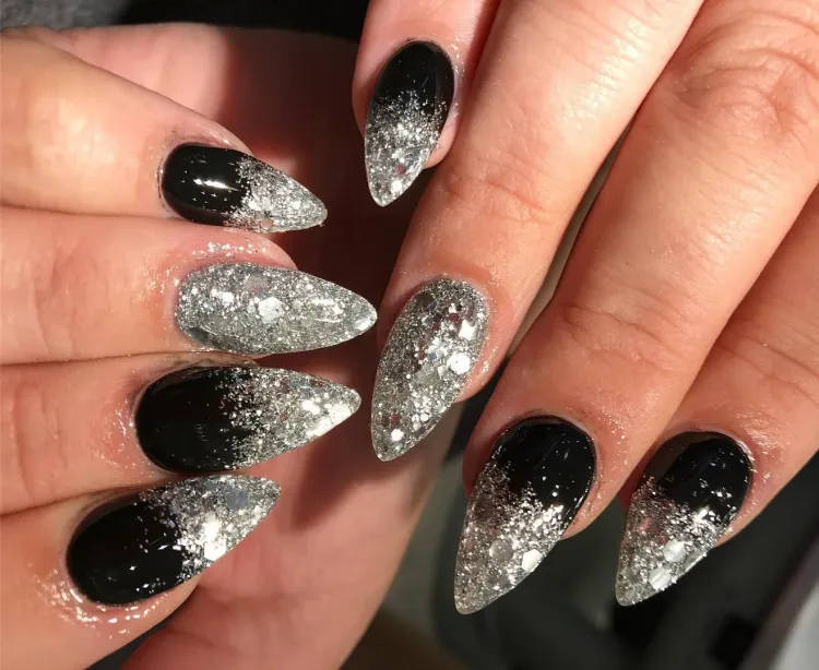 black and silver glitter nail polish on long almond shaped nails gradient effect
