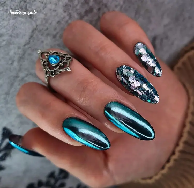 blue chrome nails with decorations very chic fatal woman vibe long manicure