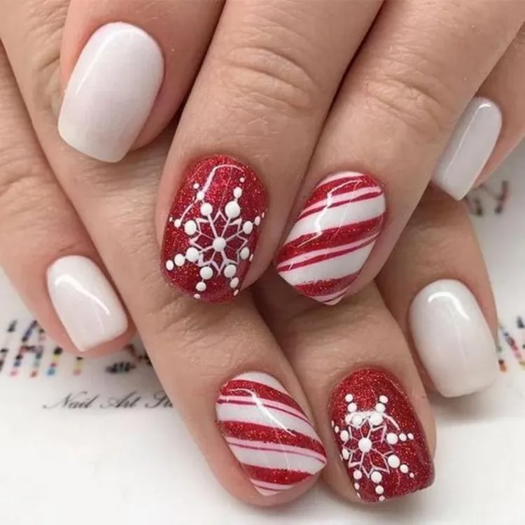 Christmas nail art in red and white with snowflakes
