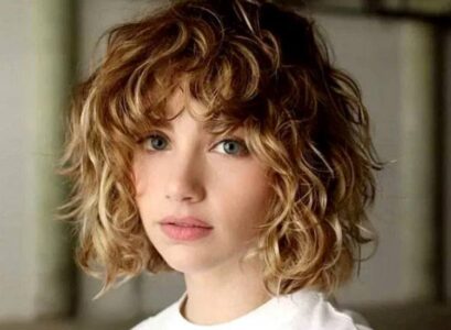 curly messy short bob idea with layered bangs blonde hair with highlights