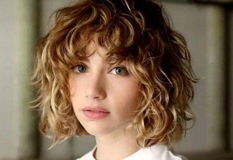 curly messy short bob idea with layered bangs blonde hair with highlights